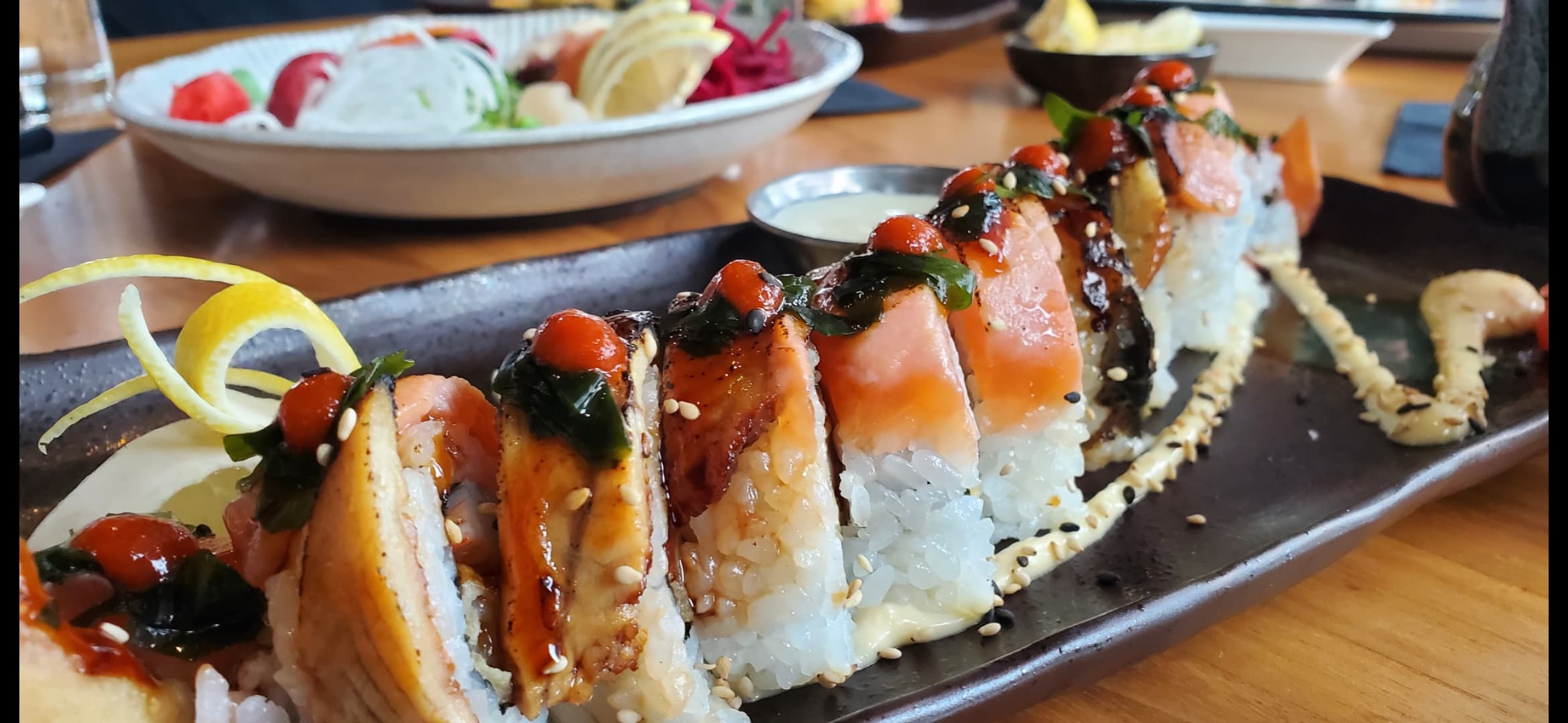 A sushi roll photographed at table level