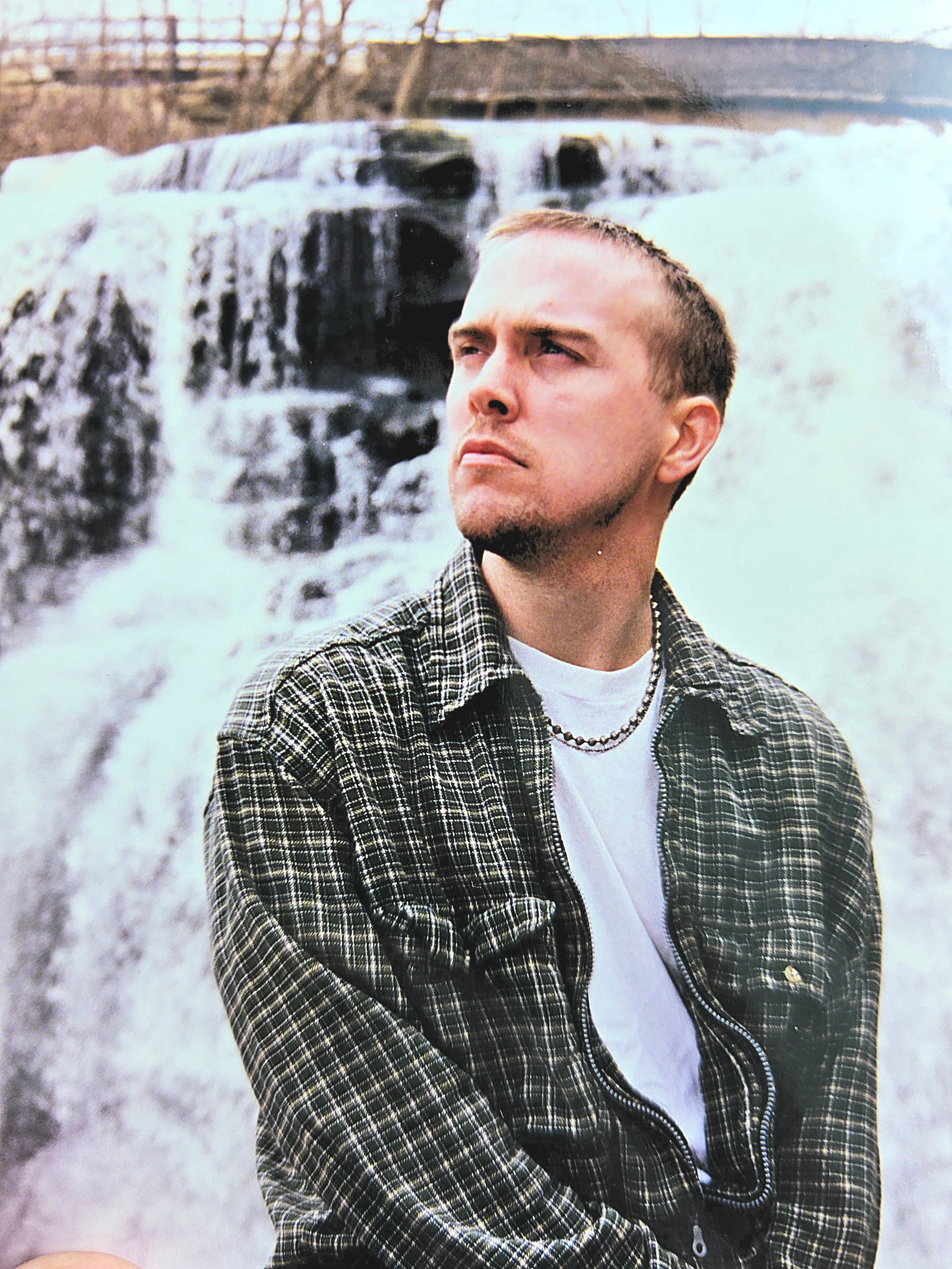 Kene Bell beside a waterfall in Akron during an early-years photo shoot