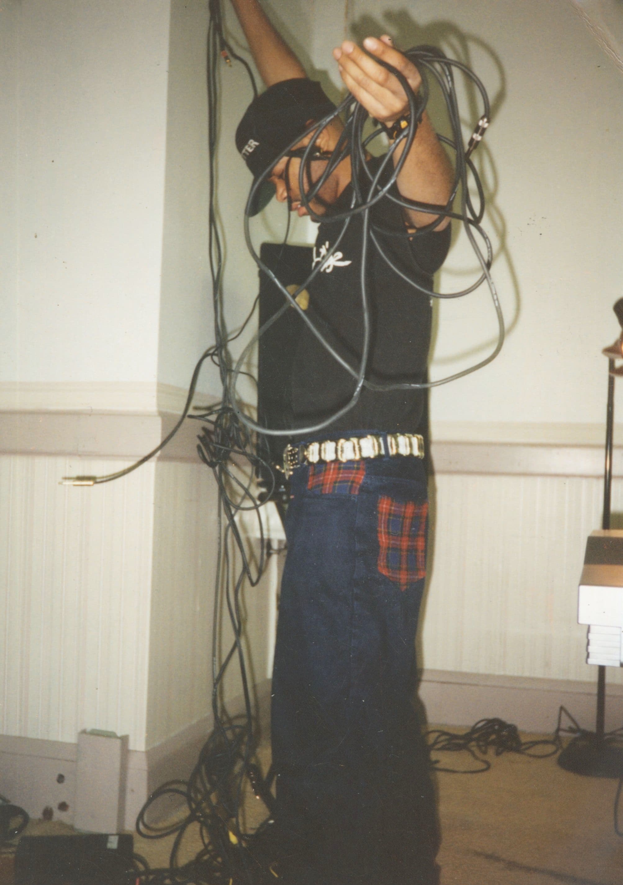 Mike Jackson working with cabling and equipment in his Akron studio