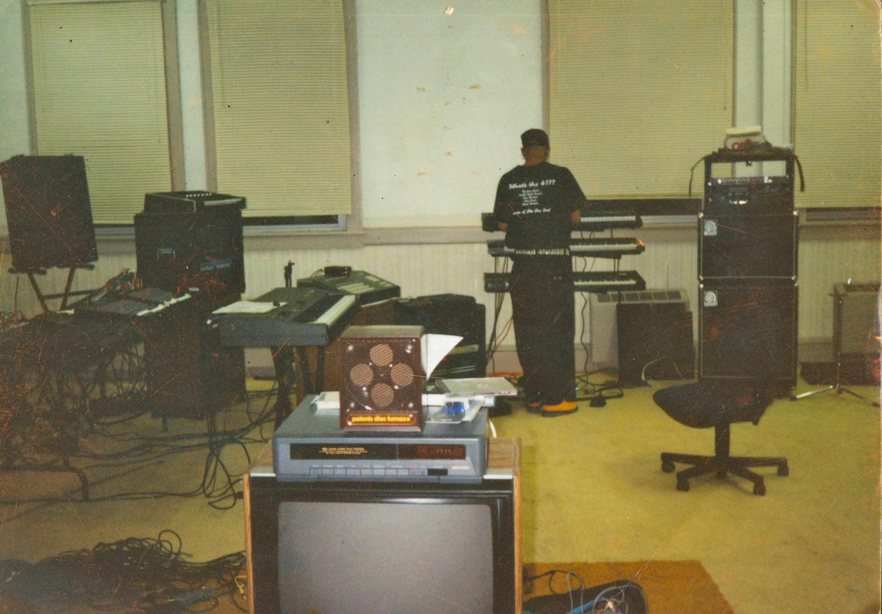 Mike Jackson seated at keyboards in his Akron studio
