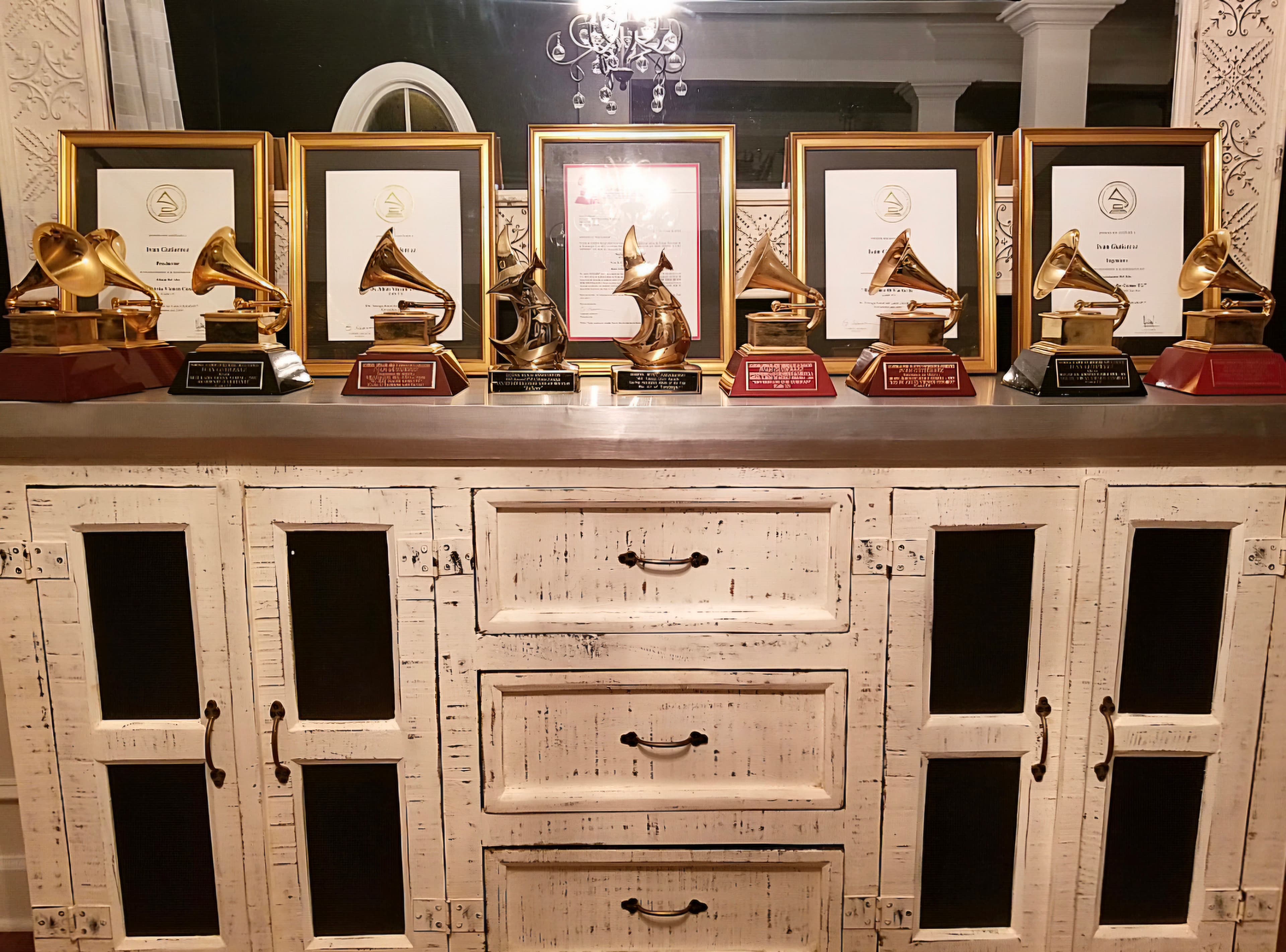 Ivan Gutierrez's awards and framed certificates displayed across a cabinet