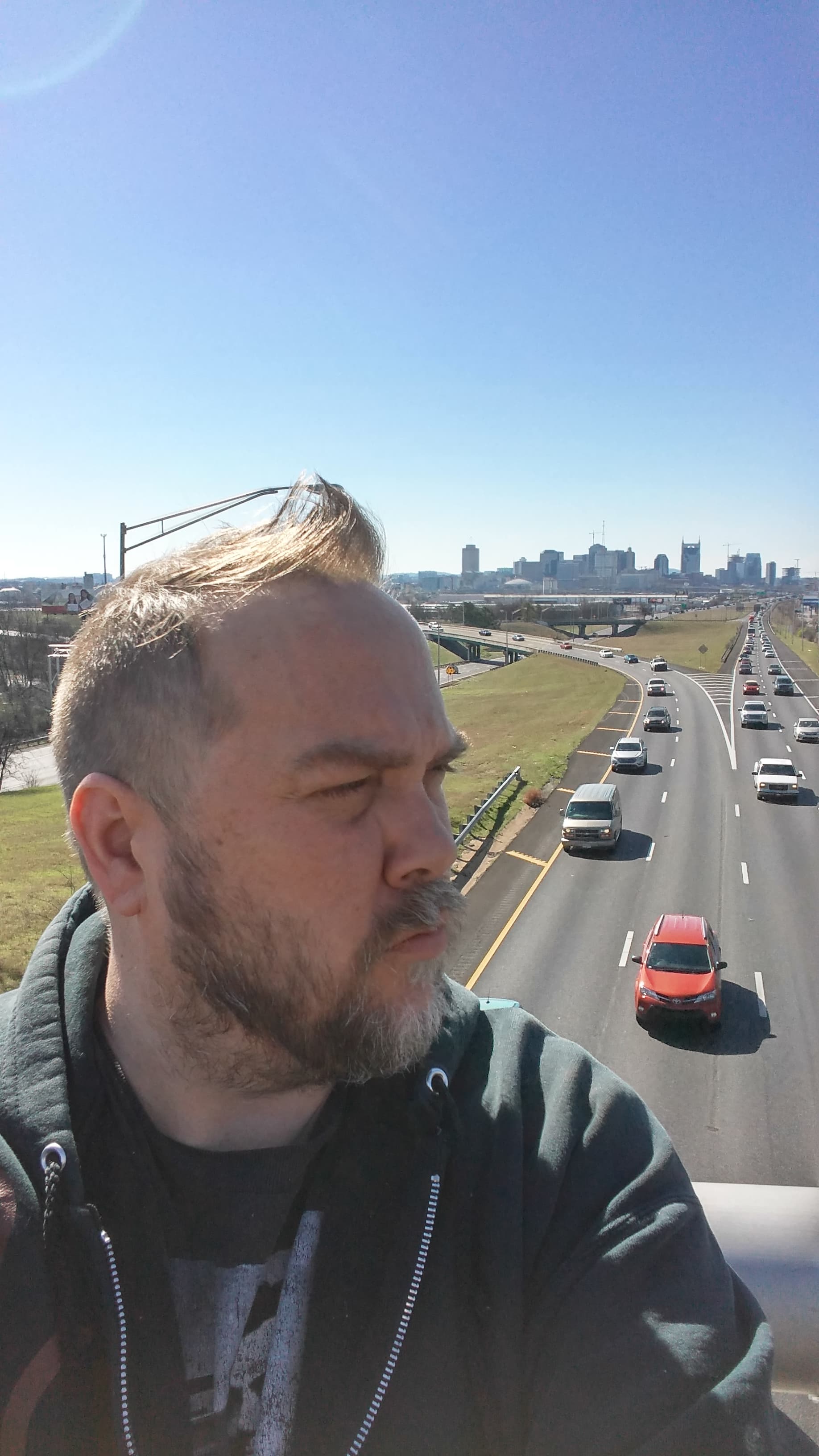 Kene Bell with the Nashville skyline and interstate stretching behind him