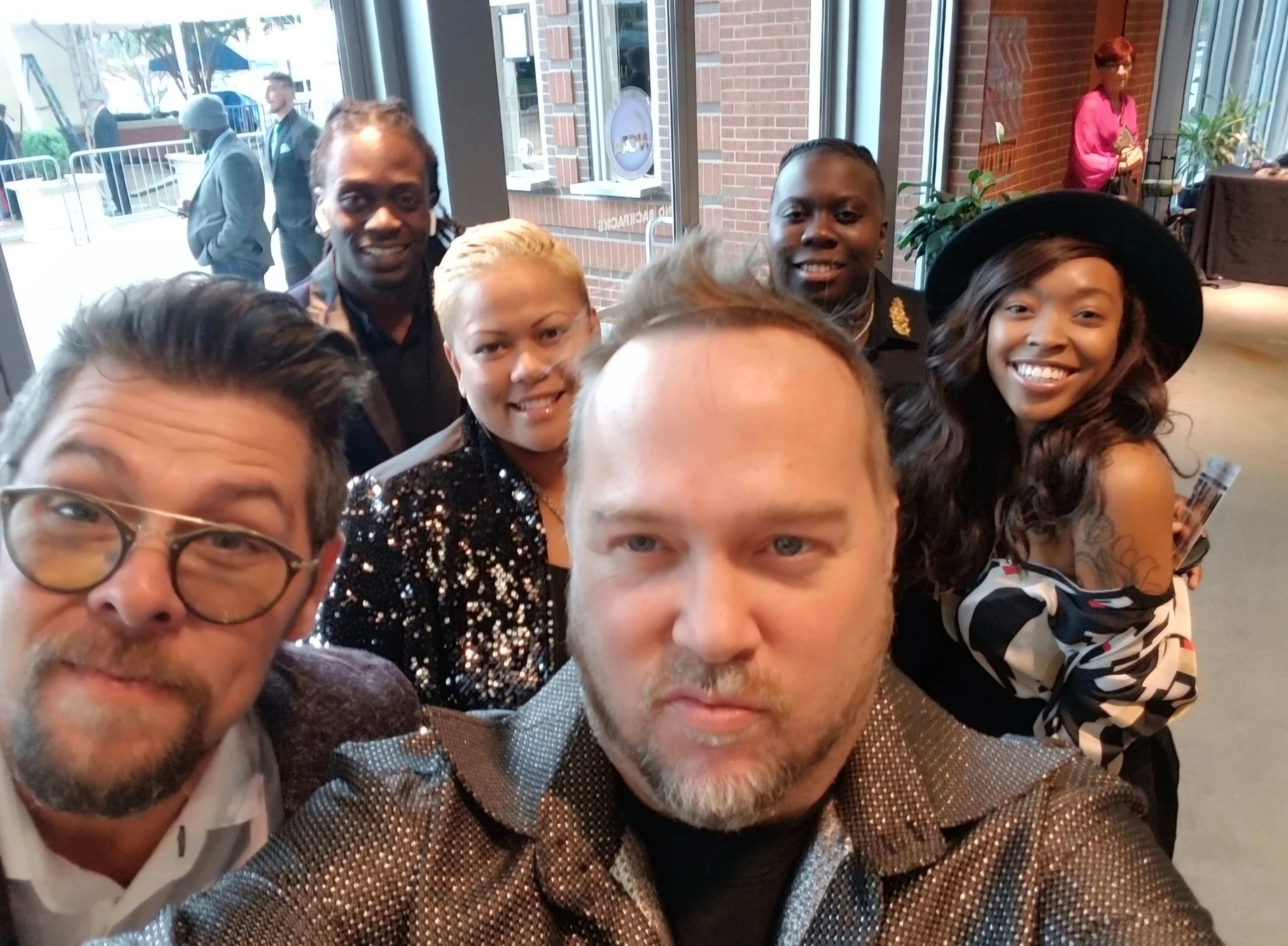 Kene Bell and friends gathered for a group photograph inside a restaurant
