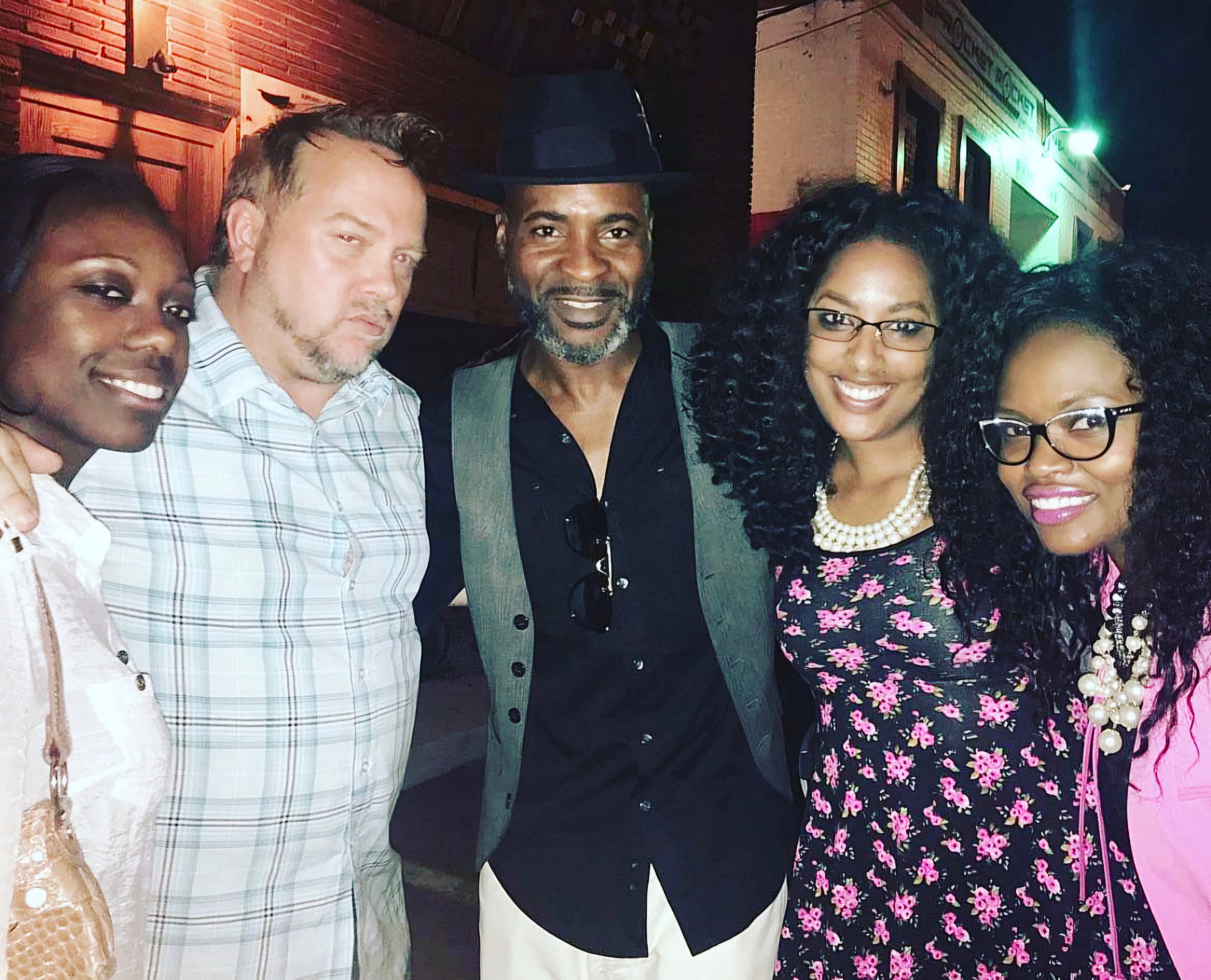 Kene Bell with friends gathered outdoors at night