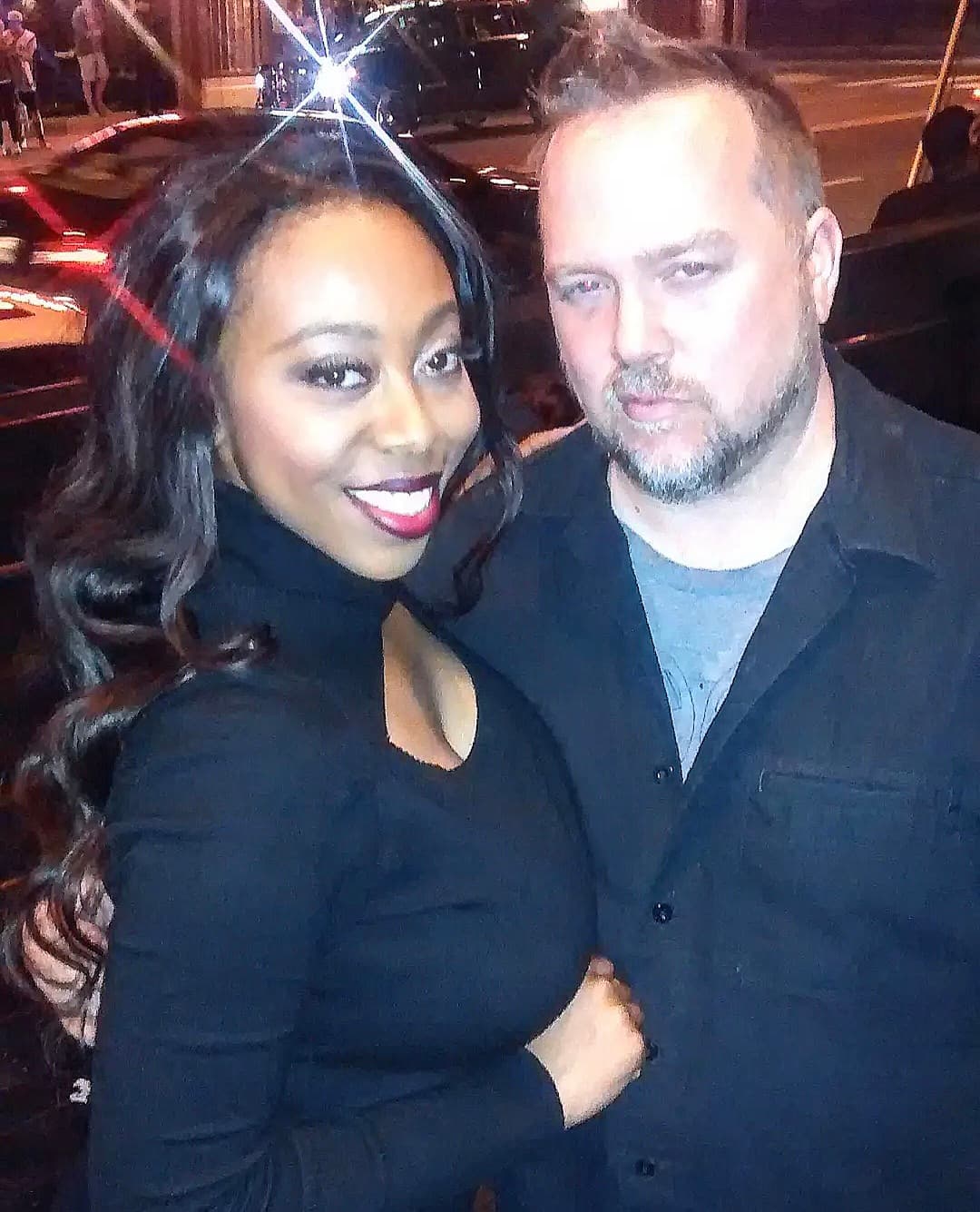 Kene Bell with a friend outdoors at night