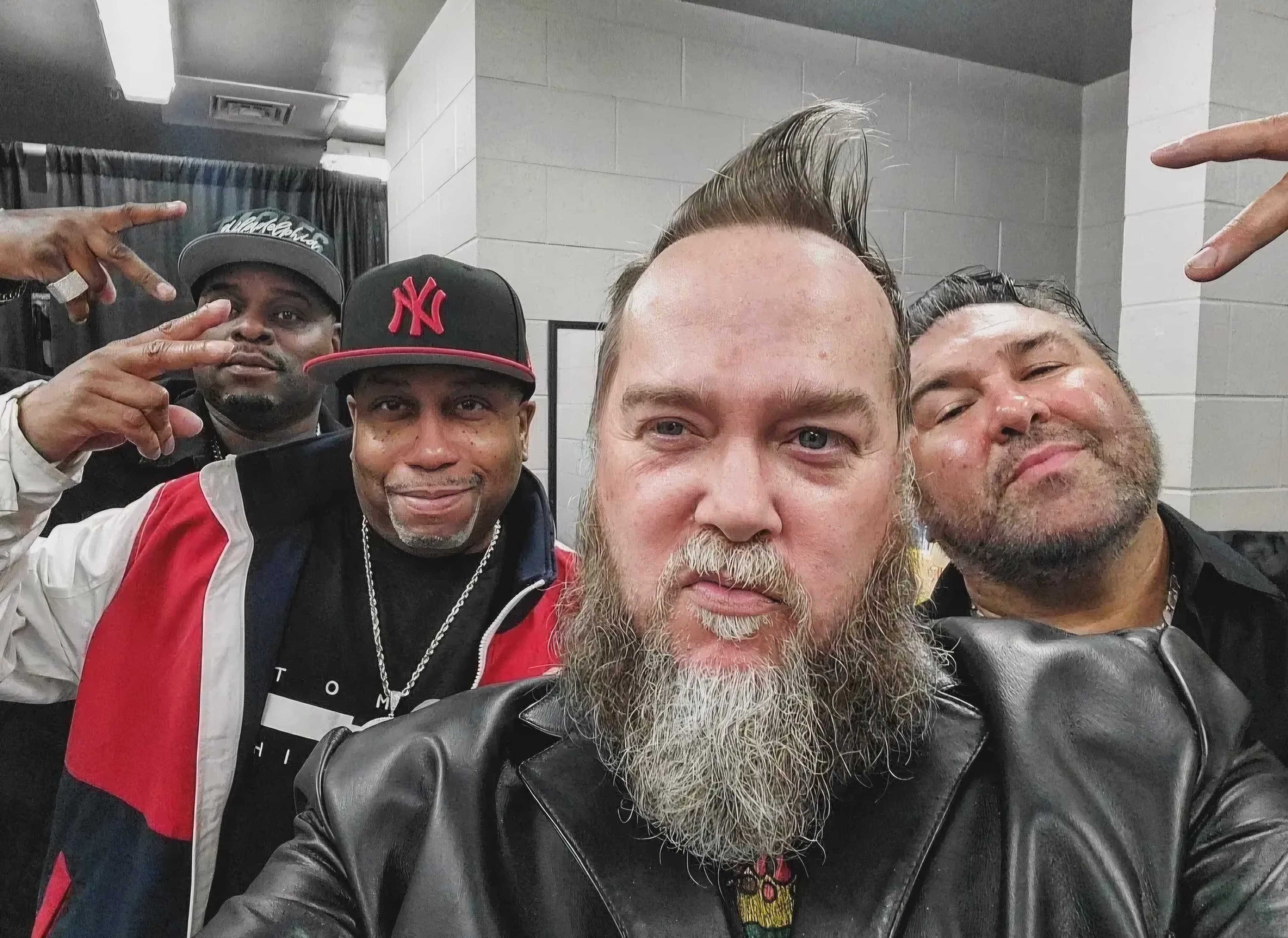Kene Bell taking a group selfie with friends in a working space
