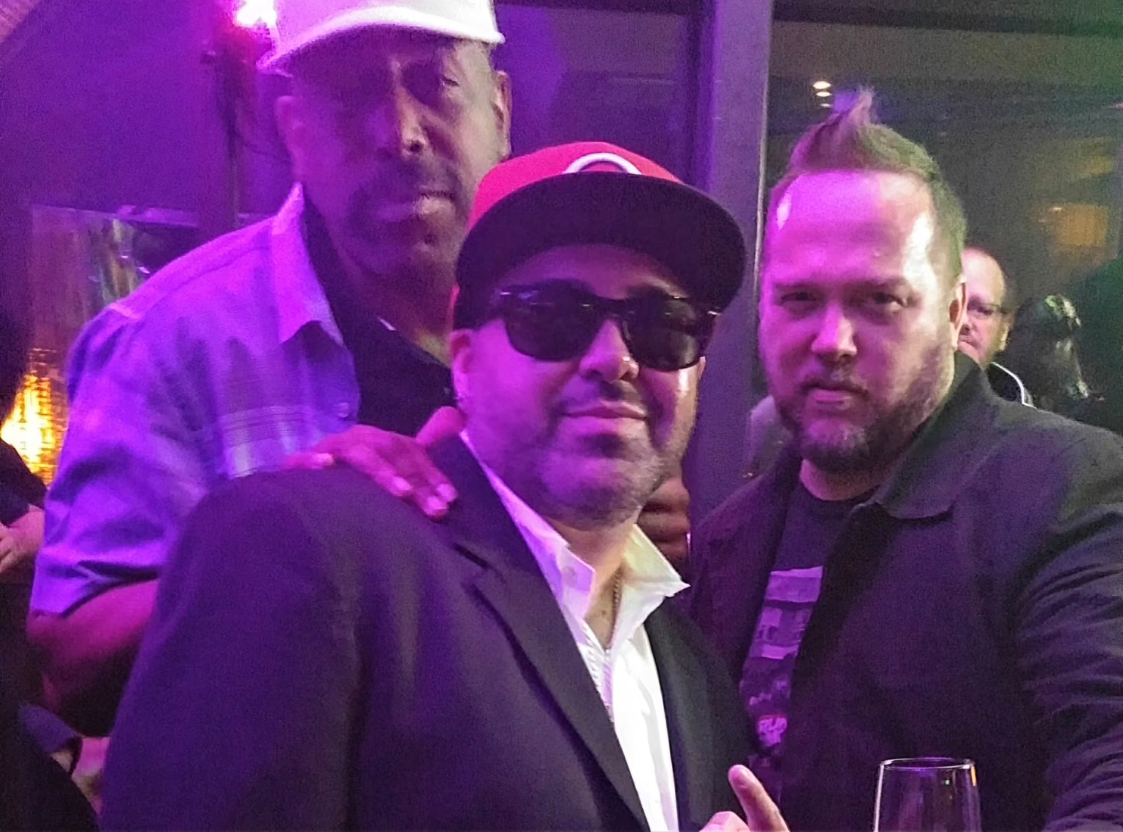 Kene Bell with two friends under purple event lighting