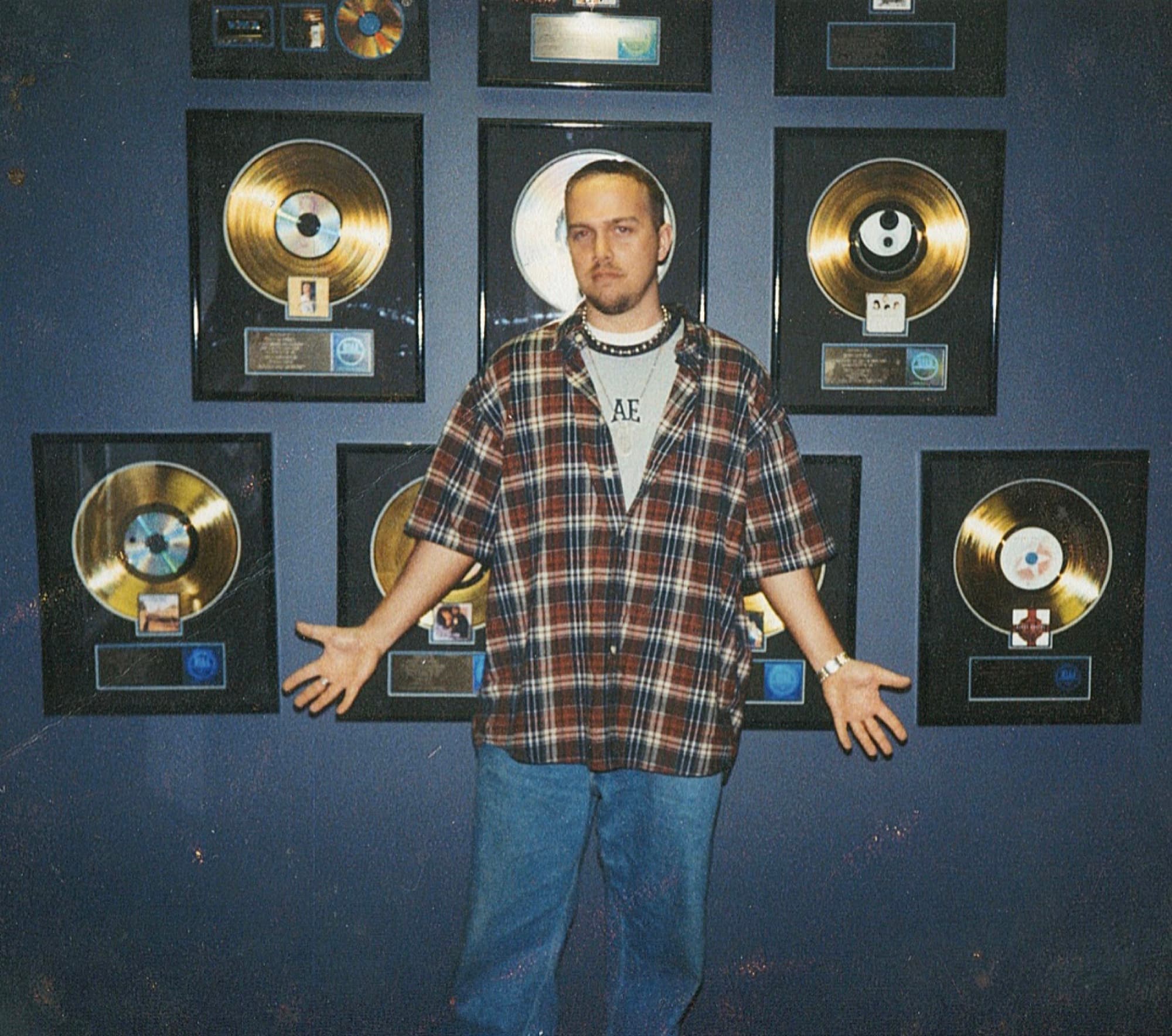 Kene Bell in a room displaying record plaques