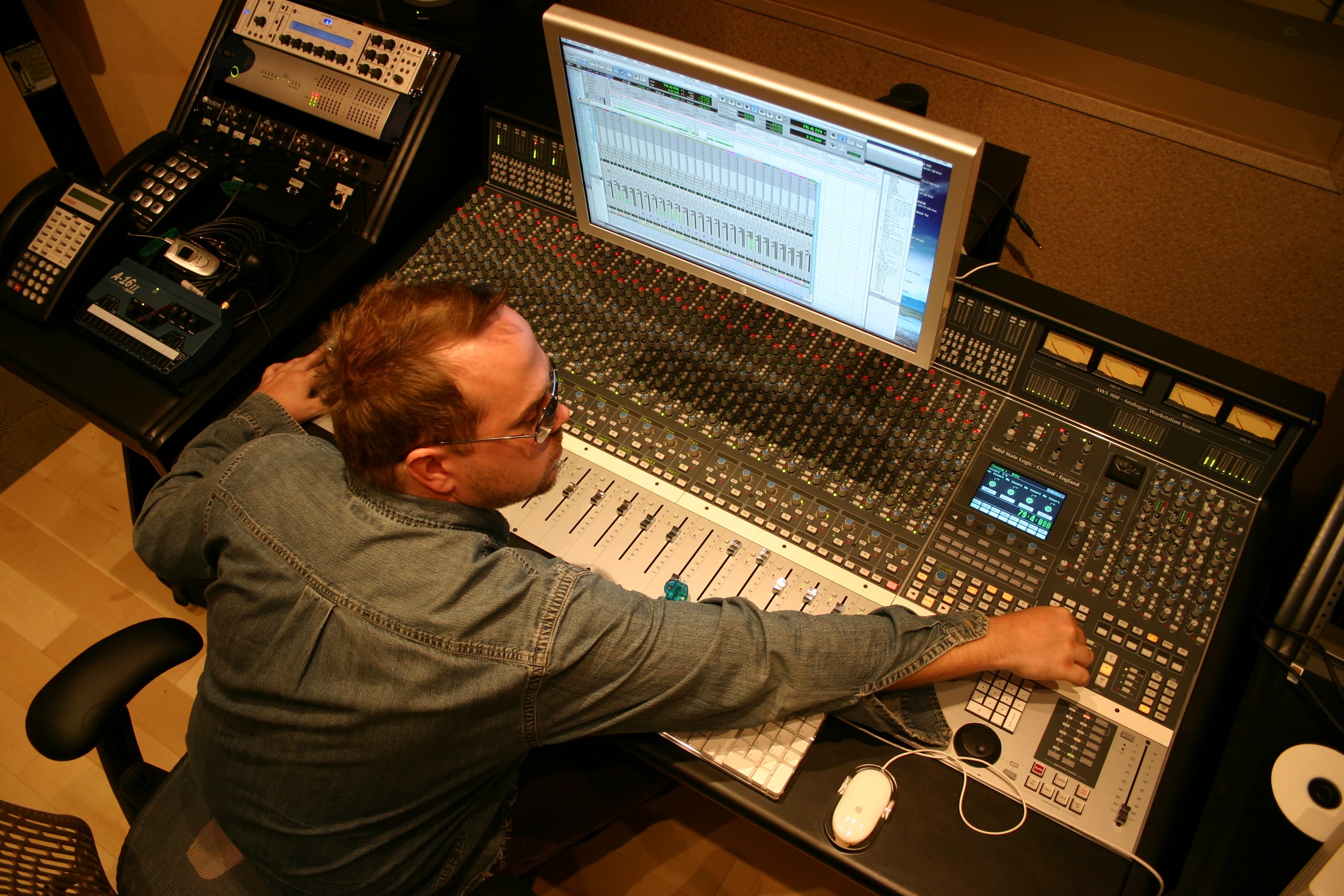 Kene Bell reaching across a recording console during the Arizona period