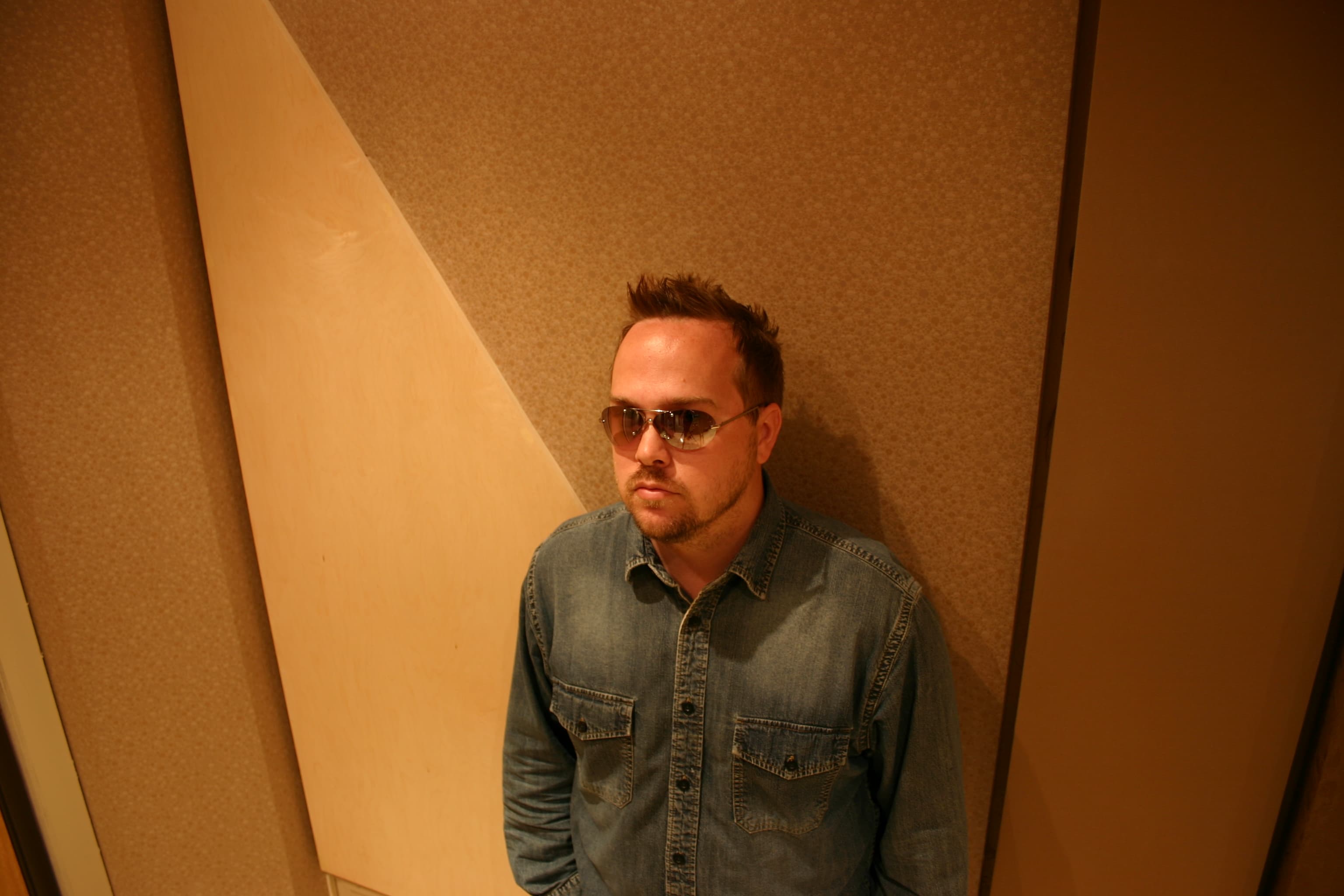 Kene Bell standing inside an Arizona recording room