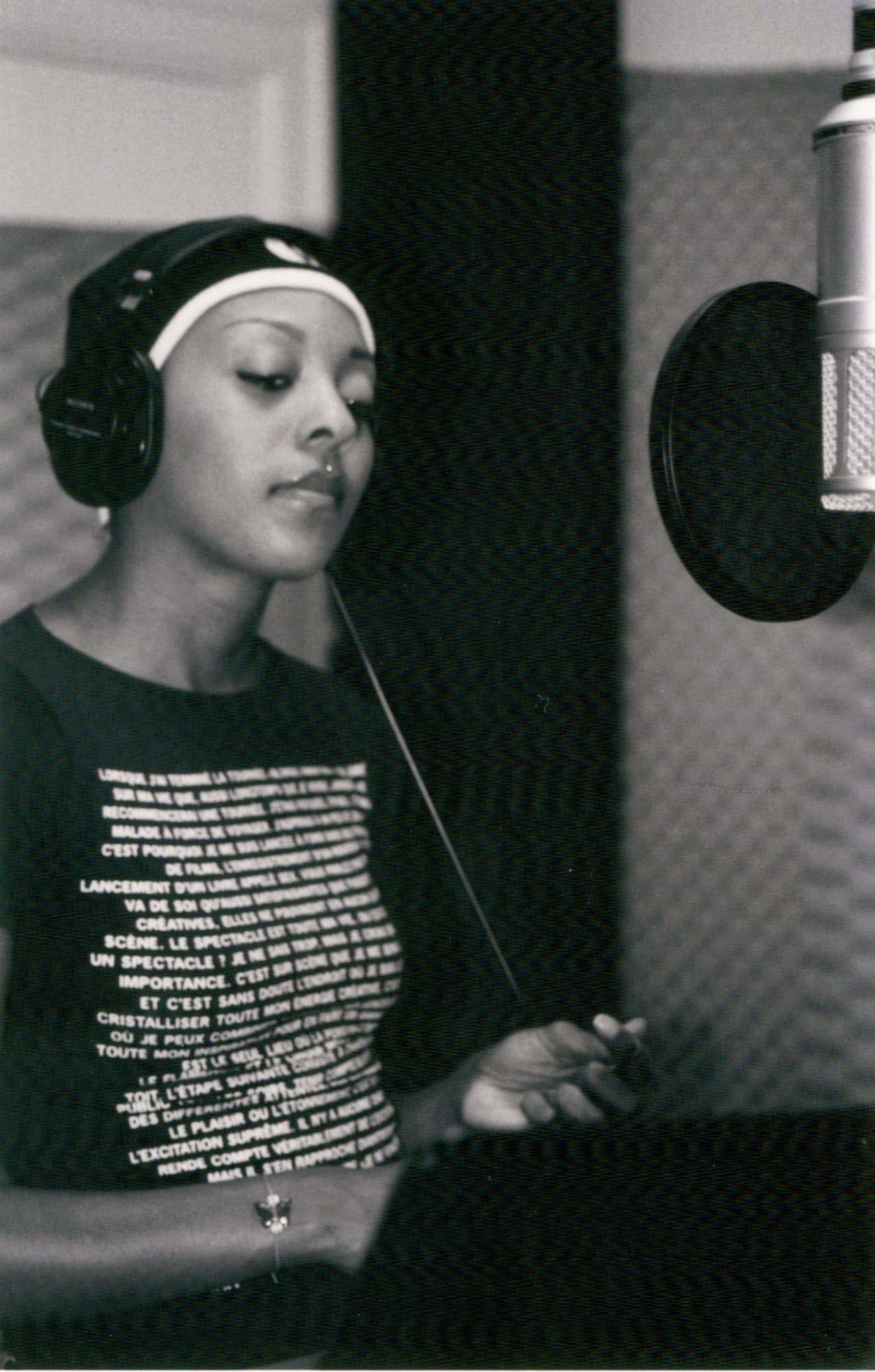 Out of Eden vocalist wearing headphones at a studio microphone