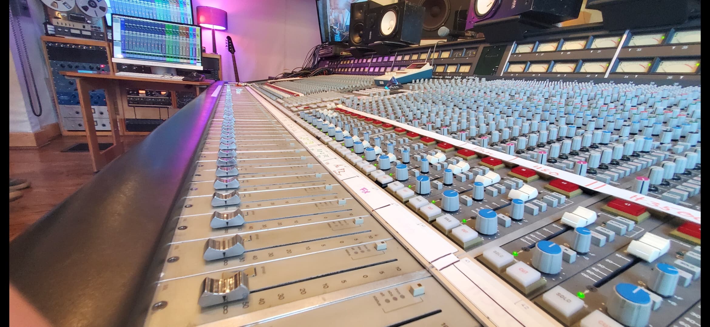 Dramatic perspective along the faders of a large-format analog mixing console