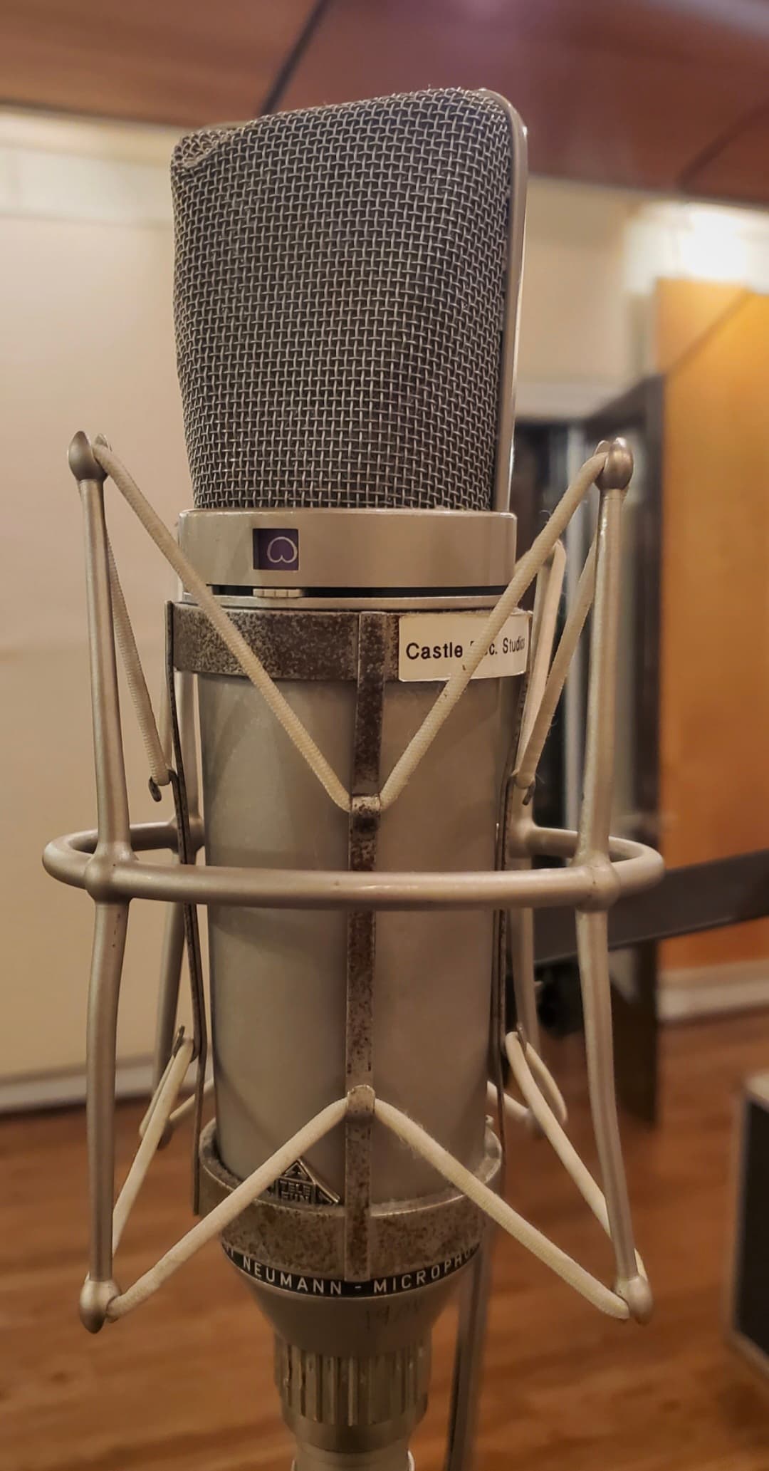 Second close view of a large Neumann studio microphone in its shock mount