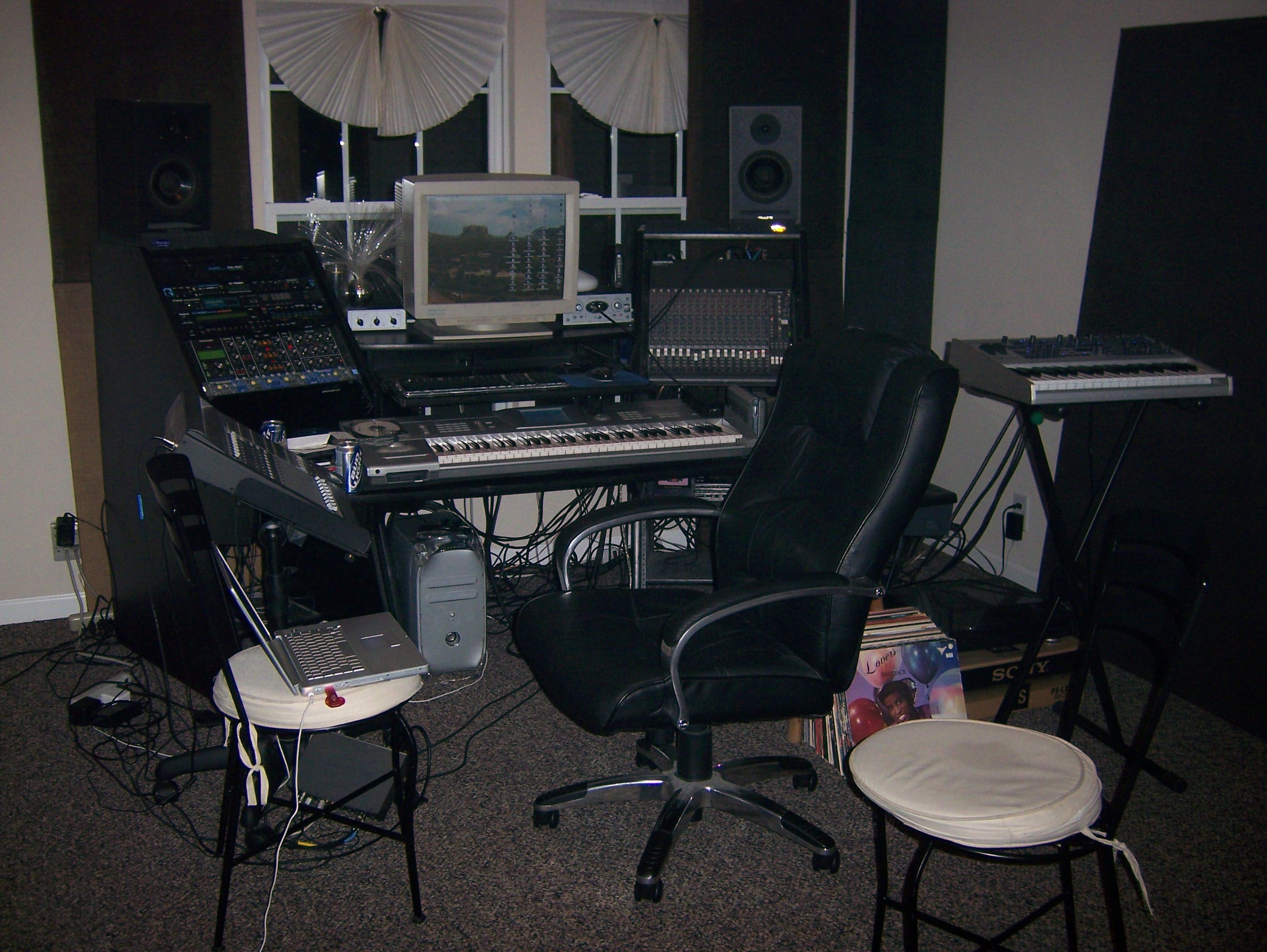 An earlier compact Ghostown Studios production room with keyboards, speakers, and an older computer