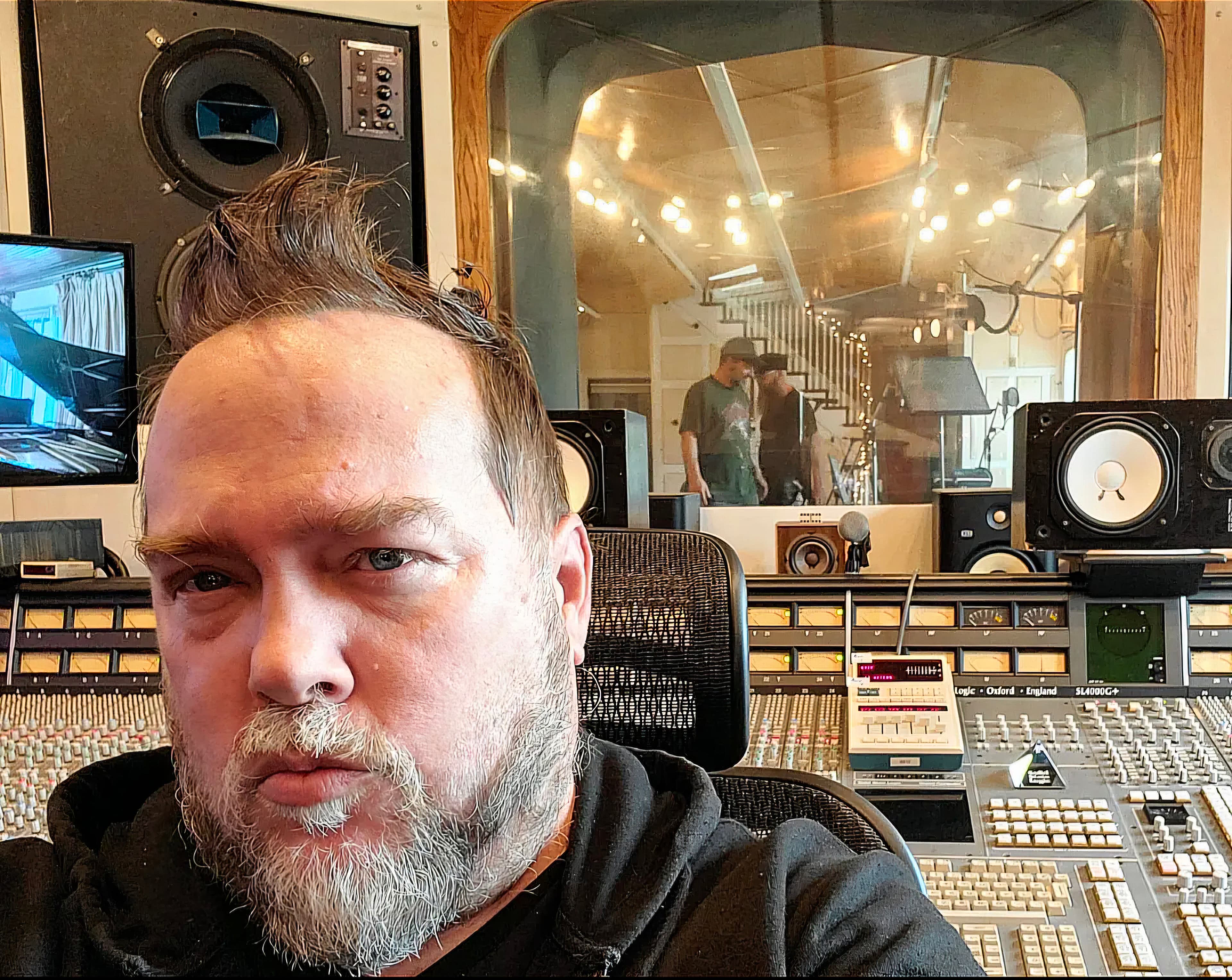 Producer working in a professional large-format control room